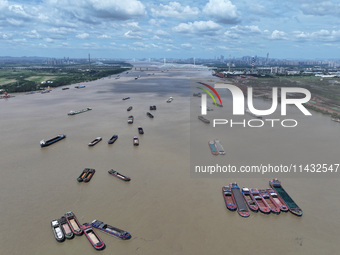 Cargo ships are anchoring in the waters of the Nanjing section of the Yangtze River in Nanjing, Jiangsu province, China, on July 25, 2024. O...