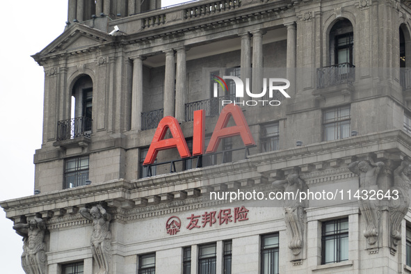 The AIA Building on the Bund in the Huangpu district of Shanghai, China, on July 25, 2024, is standing prominently. 