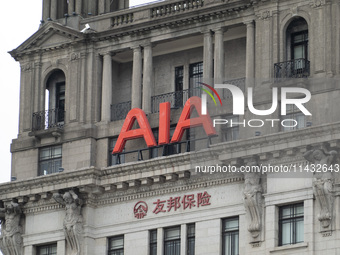 The AIA Building on the Bund in the Huangpu district of Shanghai, China, on July 25, 2024, is standing prominently. (