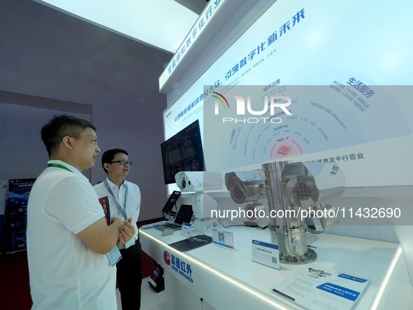 Visitors are visiting the ''Explosion-proof thermal imaging three-eye head'' at the ''Fifth World Photonics Congress 2024'' in Beijing, Chin...