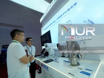 Visitors are visiting the ''Explosion-proof thermal imaging three-eye head'' at the ''Fifth World Photonics Congress 2024'' in Beijing, Chin...