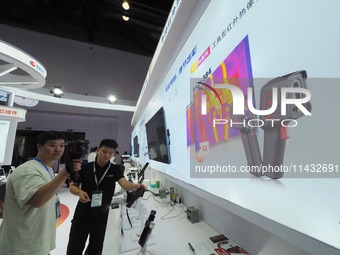 Visitors are experiencing the ''intelligent infrared thermal imager'' at the ''Fifth World Photonics Congress 2024'' in Beijing, China, on J...