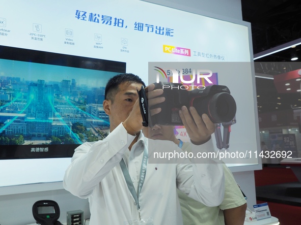 Visitors are experiencing the ''infrared thermal imager'' at the ''Fifth World Photonics Congress 2024'' in Beijing, China, on July 25, 2024...