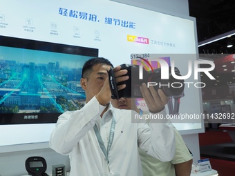 Visitors are experiencing the ''infrared thermal imager'' at the ''Fifth World Photonics Congress 2024'' in Beijing, China, on July 25, 2024...