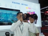 Visitors are experiencing the ''infrared thermal imager'' at the ''Fifth World Photonics Congress 2024'' in Beijing, China, on July 25, 2024...