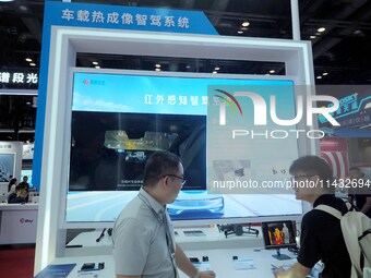 Visitors are visiting the ''Infrared Sensing Intelligent Driving System'' at the ''Fifth World Photonics Congress 2024'' in Beijing, China,...