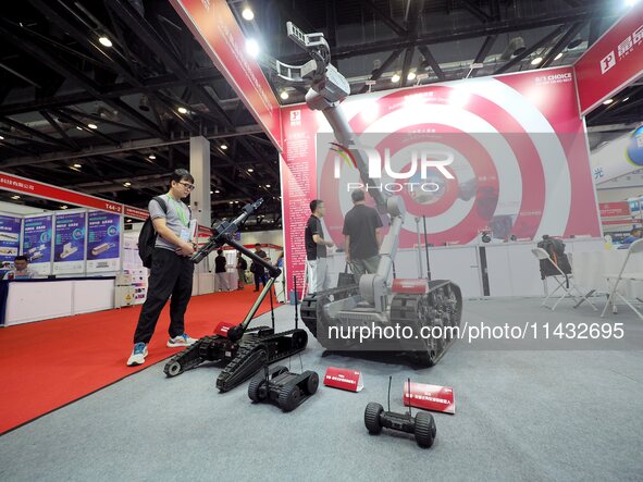 Visitors are visiting the ''Explosive disposal robot'' at the ''Fifth World Photonics Congress 2024'' in Beijing, China, on July 25, 2024. 