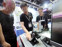 Visitors are visiting the ''Six-axis core tuning System'' at the ''Fifth World Photonics Congress 2024'' in Beijing, China, on July 25, 2024...