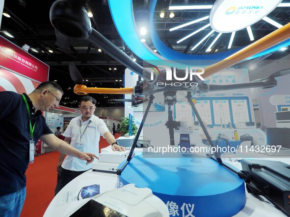 Visitors are visiting a ''drone Borne hyperspectral Imager'' at the ''Fifth World Photonics Congress 2024'' in Beijing, China, on July 25, 2...