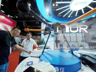 Visitors are visiting a ''drone Borne hyperspectral Imager'' at the ''Fifth World Photonics Congress 2024'' in Beijing, China, on July 25, 2...