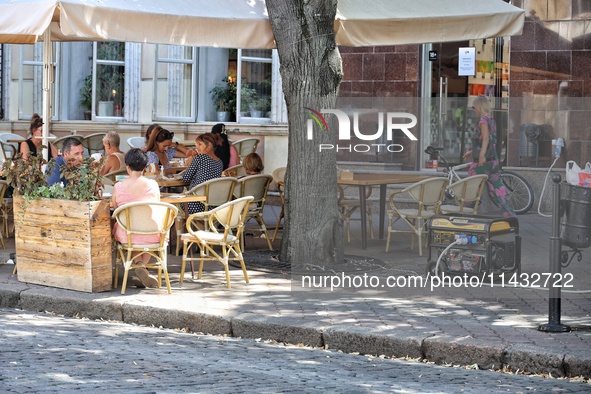 A diesel generator is being used as a backup during power outages near an outdoor cafe in Odesa, Ukraine, on July 23, 2024. NO USE RUSSIA. N...