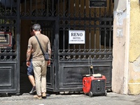 Men are stepping through the gate near a diesel generator used as a backup during power outages in Odesa, Ukraine, on July 23, 2024. NO USE...