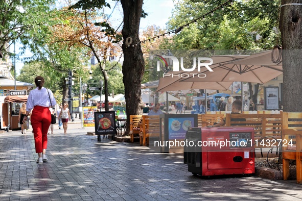 A diesel generator is being used as a backup during power outages by a cafe terrace in Odesa, Ukraine, on July 23, 2024. NO USE RUSSIA. NO U...