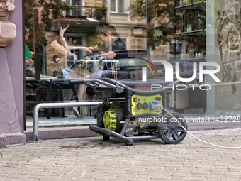 A diesel generator is being used as a backup during power outages outside a beauty salon in Odesa, Ukraine, on July 24, 2024. NO USE RUSSIA....