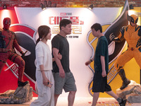 People are walking past a billboard of the Marvel Studios movie 'Deadpool & Wolverine' in Seoul, South Korea, on July 25, 2024. The movie 'D...