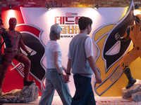 A couple is walking past a billboard of Marvel Studios movie 'Deadpool & Wolverine' in Seoul, South Korea, on July 25, 2024. The movie 'Dead...