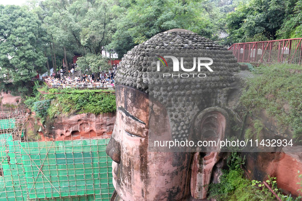 Tourists are visiting the Leshan Giant Buddha scenic spot in Leshan, China, on July 25, 2024. 