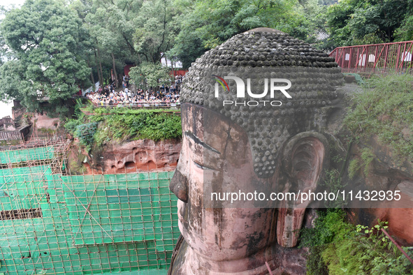 Tourists are visiting the Leshan Giant Buddha scenic spot in Leshan, China, on July 25, 2024. 