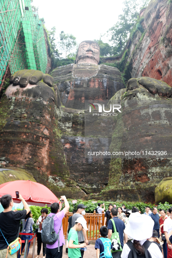 Tourists are visiting the Leshan Giant Buddha scenic spot in Leshan, China, on July 25, 2024. 