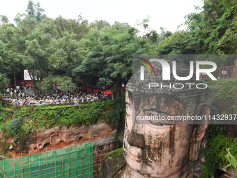 Tourists are visiting the Leshan Giant Buddha scenic spot in Leshan, China, on July 25, 2024. (