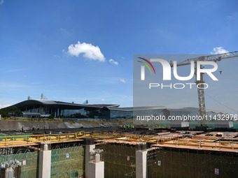 Construction workers are pouring concrete on the middle slab (platform floor) of the Changbei Airport Station of the Beijing-Hong Kong high-...