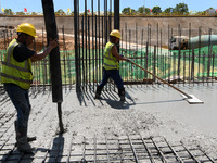 Construction workers are pouring concrete on the middle slab (platform floor) of the Changbei Airport Station of the Beijing-Hong Kong high-...