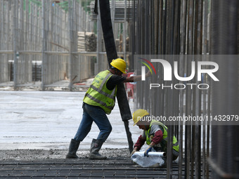 Construction workers are pouring concrete on the middle slab (platform floor) of the Changbei Airport Station of the Beijing-Hong Kong high-...