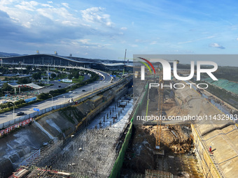 Construction workers are pouring concrete on the middle slab (platform floor) of the Changbei Airport Station of the Beijing-Hong Kong high-...