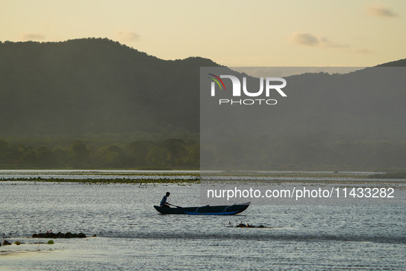 A man is fishing from the boat at a lake in Dambulla, Sri Lanka, on July 25, 2024 