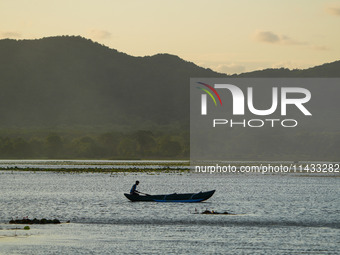 A man is fishing from the boat at a lake in Dambulla, Sri Lanka, on July 25, 2024 (