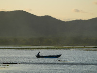 A man is fishing from the boat at a lake in Dambulla, Sri Lanka, on July 25, 2024 (