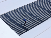 A woman is using an umbrella to protect herself from the sun in Singapore, on July 25, 2024. (