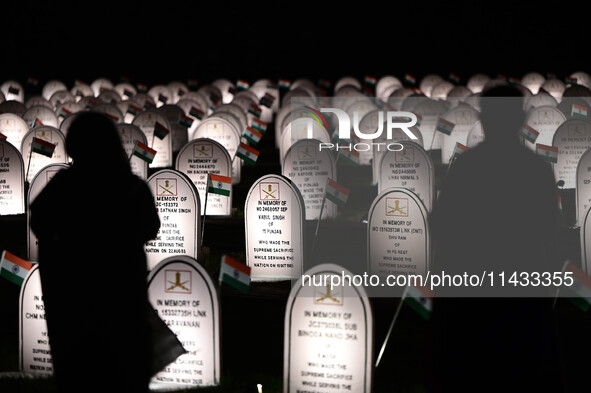 People are standing next to the war memorial during the ''Vijay Diwas'' or Victory Day celebration in Drass, Jammu and Kashmir, on July 25,...