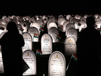 People are standing next to the war memorial during the ''Vijay Diwas'' or Victory Day celebration in Drass, Jammu and Kashmir, on July 25,...