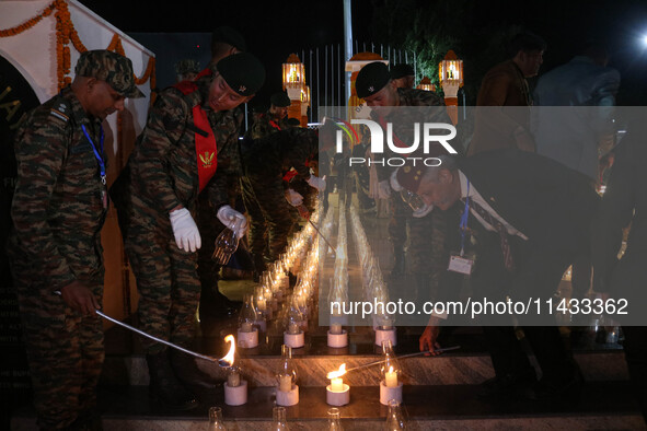 Indian Army soldiers are lighting candles at a war memorial during the ''Vijay Diwas'' or Victory Day celebration in Drass, about 160 km (99...