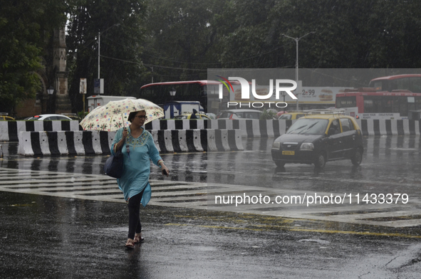 A woman is carrying an umbrella during rainfall in Mumbai, India, on July 25, 2024. 