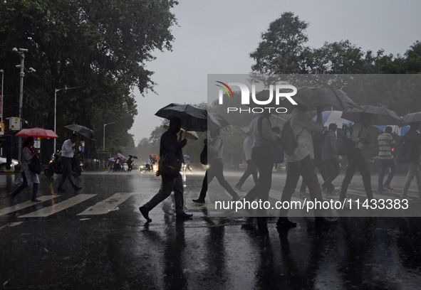 People are carrying umbrellas during rainfall in Mumbai, India, on July 25, 2024. 