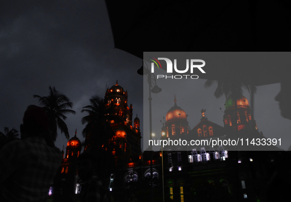 People are carrying umbrellas during rainfall in Mumbai, India, on July 25, 2024. 