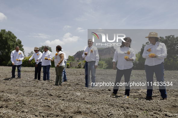 They are symbolically sowing Cempasuchil Flower seeds during the presentation of the strategic project for the conservation of the Cempoalxo...