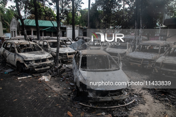 A view of burnt cars inside the Bangladesh Bridge Authority compound is showing the aftermath of students setting them on fire amid the ongo...