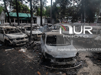 A view of burnt cars inside the Bangladesh Bridge Authority compound is showing the aftermath of students setting them on fire amid the ongo...