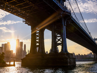  A view on Manhattan Bridge and Manhattan sklyline during sunset over the East River in New York City, United States of America on July 7th,...