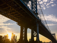  A view on Manhattan Bridge and Manhattan sklyline during sunset over the East River in New York City, United States of America on July 7th,...