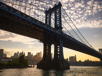  A view on Manhattan Bridge and Manhattan sklyline during sunset over the East River in New York City, United States of America on July 7th,...