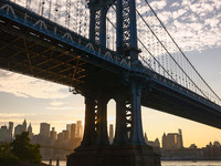  A view on Manhattan Bridge and Manhattan sklyline during sunset over the East River in New York City, United States of America on July 7th,...