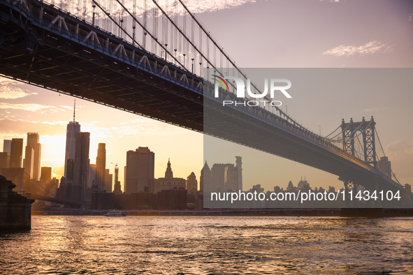  A view on Manhattan Bridge and Manhattan sklyline during sunset over the East River in New York City, United States of America on July 7th,...