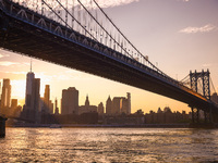  A view on Manhattan Bridge and Manhattan sklyline during sunset over the East River in New York City, United States of America on July 7th,...