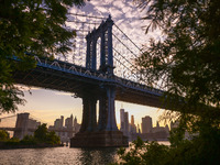  A view on Manhattan Bridge and Manhattan sklyline during sunset over the East River in New York City, United States of America on July 7th,...