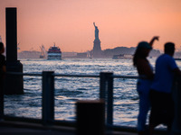  Sunset over the East River and a view on the Statue of Liberty in New York City, United States of America on July 7th, 2024.  (