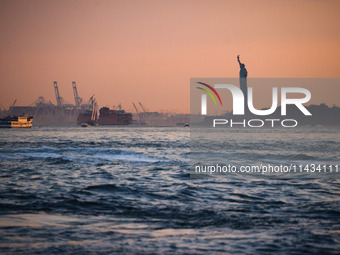  Sunset over the East River and a view on the Statue of Liberty in New York City, United States of America on July 7th, 2024.  (